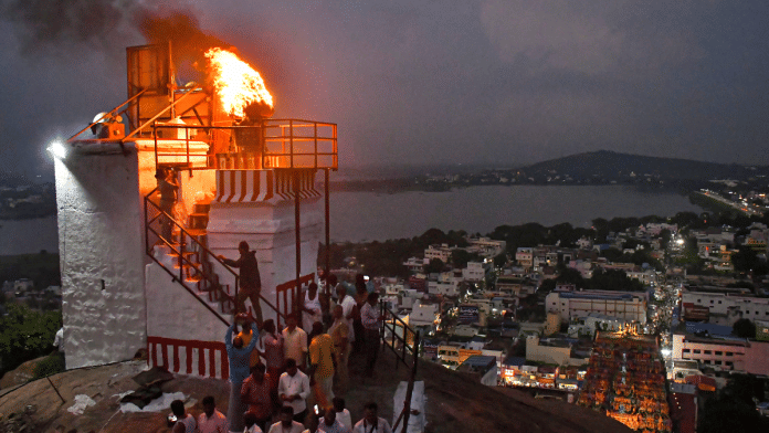 A lamp is lit at Thiruparankundram temple as part of 'Karthigai Deepam' festival celebration in Madurai, Tamil Nadu | PTI