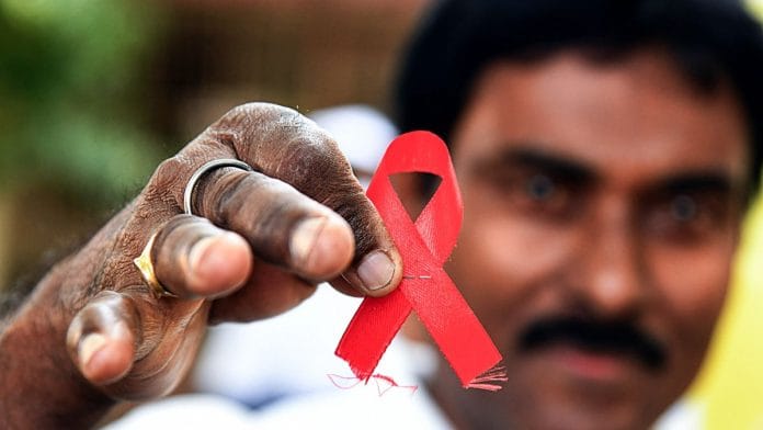 Representational image of healthcare worker holding a red ribbon, a symbol of solidarity with people with HIV/AIDS | ANI