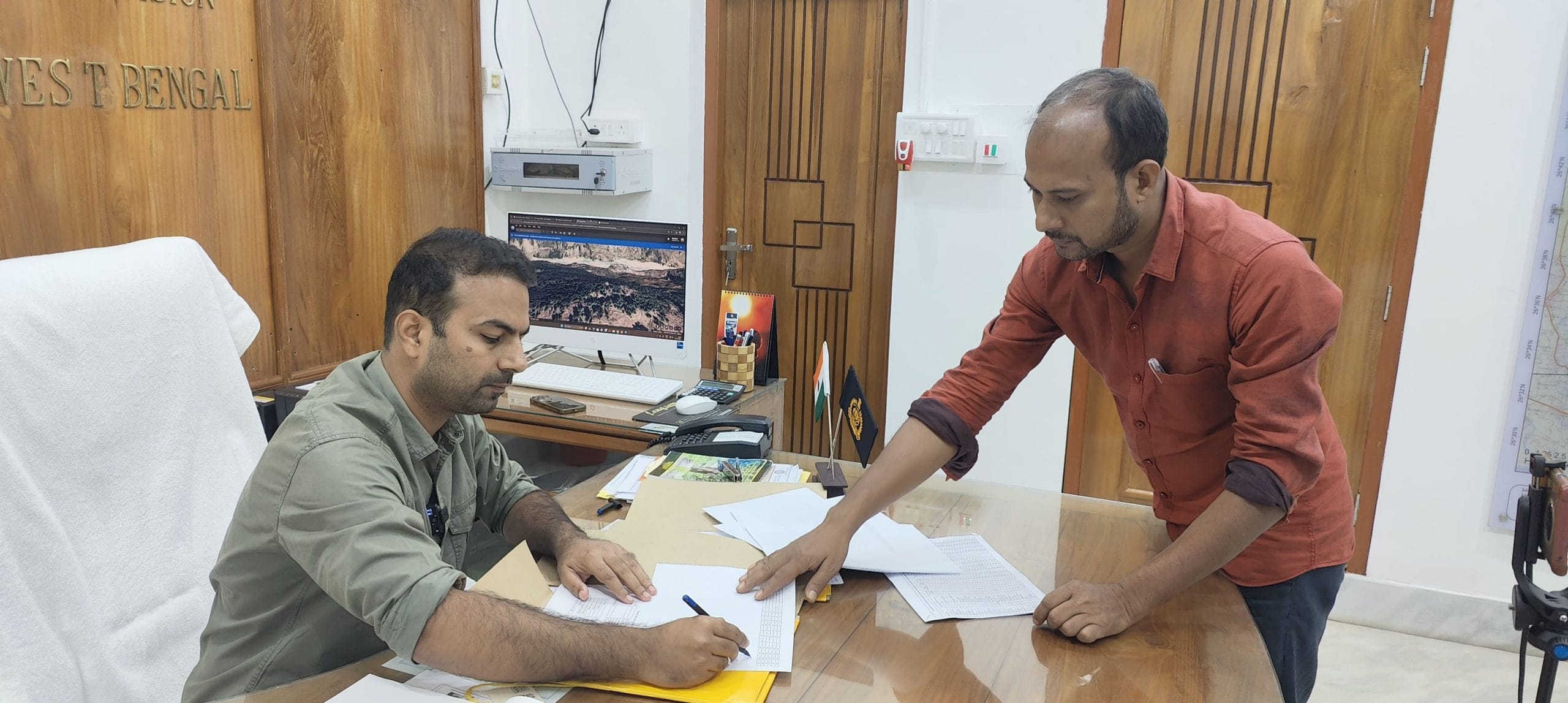 DFO Jaldapara Parveen Kaswan in his office, signing a file