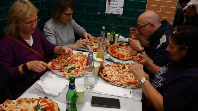 People eat pizzas at L'antica Pizzeria da Michele in Naples. | Ciro De Luca | Reuters