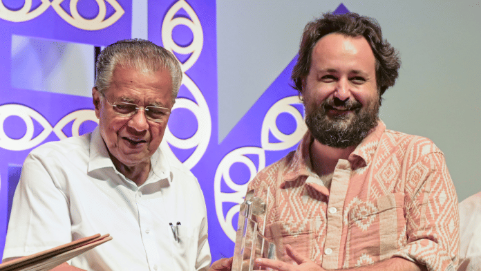 Chief Minister Pinarayi Vijayan presents the best director award to Saumyananda Sahi for the film 'Shadowbox' during the 30th International Film Festival of Kerala, in Thiruvananthapuram | PTI