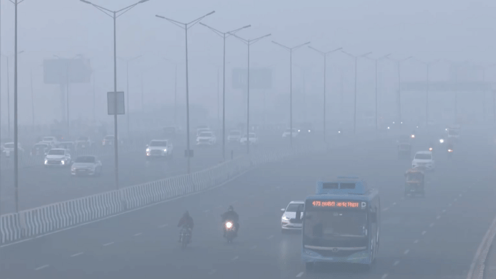 Screengrab from visuals showing thick smog as vehicles run on Delhi roads with headlights on, Tuesday, 16 December 2025 | X/@ANI