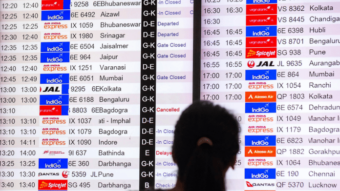 Representational image. Passenger looks at information board at New Delhi airport as IndiGo cancelled hundreds of flights last week. | ANI